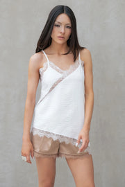 Blusa fluida larga de tirantes delgados ajustables, escote v con escote decorativo en contraste, cut out diagonal y bajo asimétrico frontal.