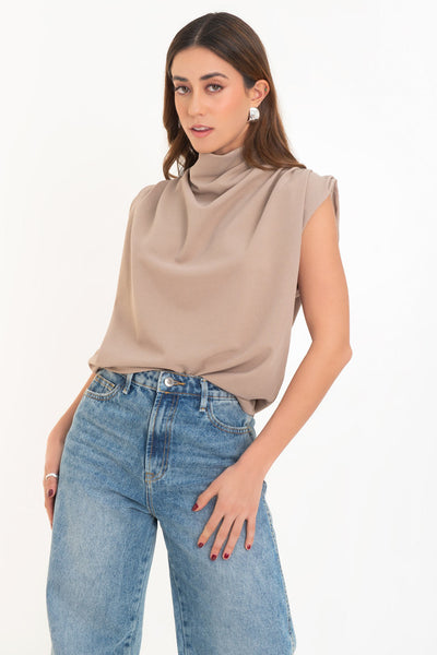 Blusa de fit oversized, sin mangas y cuello alto con detalles plisados en hombros.