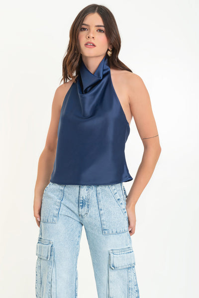 Blusa satinada de cuello halter con escote fluido, sin mangas y escote en espalda. Cierre posterior con botón y ojal.