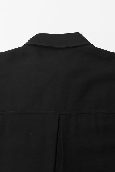 Camisa corta de estilo utilitario. Corte recto, silueta amplia y largo crop. Frente con cuello camisero clásico, tapeta de botones y dos bolsillos con tapa en el pecho. Espalda con canesú y tablón central invertido.