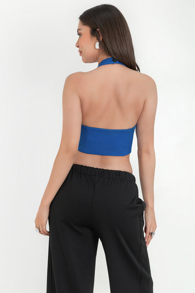 Chaleco corto cuello halter, fit ajustado, cierre frontal con hilera de botones, vivos decorativos frontales y bajo v curveado. Escote en espalda.