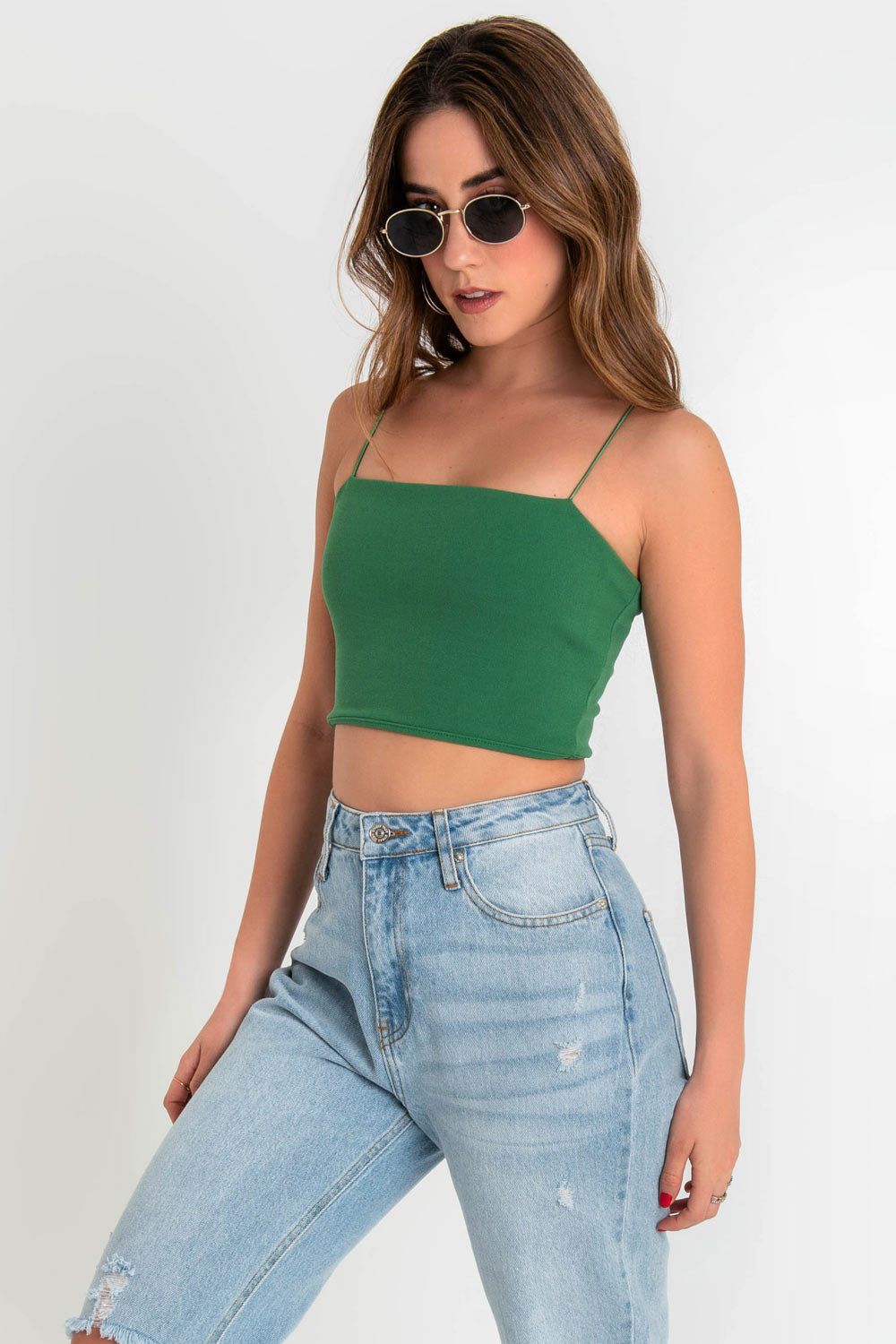 Crop top bandeau de fit ajustado, escote recto y tirantes delgados elásticos. Cierre posterior con cremallera visible.