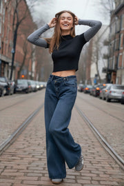 Pantalón de denim, fit wide leg, tiro alto, pretina criss cross con trabillas, bolsillos delanteros y traseros de parche. Cierre frontal con botón y cremallera oculta.