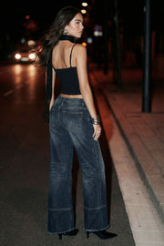 Pantalón de denim, fit wide leg, tiro medio con pretina y trabillas, bolsillos delanteros y traseros de parche. Cierre con botón y cremallera oculta. Detalle de costuras decorativas frontales.