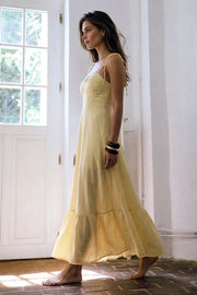 Maxi vestido de corte en a, tirantes delgados con nudo amarrable, escote corazón con cortes y detalles plisados. Cierre posterior con cremallera visible en contraste y olanes en borde de bajo.