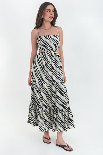 Maxi vestido estampado de corte en a, tirantes delgados ajustables, bajo con capas de olanes, cut out en costados y espalda. Detalle de rib elástico en cintura y cierre lateral con cremallera oculta.