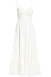 Maxi vestido de corte en a, tirantes delgados con nudo amarrables, escote corazón con cortes y detalles plisados. Cierre posterior con cremallera visible en contraste y olanes en borde de bajo.