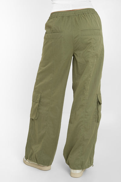 Pantalón cargo parachute de cintura media, pretina elástica con jareta frontal ajustable, fit amplio, bolsillos delanteros, laterales cargo con cartera y traseros con vivos. Detalle costuras decorativas centrales y bajo con jaretas elásticas ajustables.