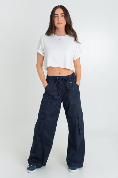 Pantalón cargo de cintura alta con pretina elástica y jareta frontal ajustable, fit wide leg, bolsillos delanteros, laterales y traseros cargo de cartera con botones. Detalle de bolsillos frontales cargo, trabillas y argolla en contraste.