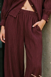 Pantalón fluido de fit balloon, cintura media con pretina elástica, bolsillos delanteros y rib elástico en bajo. Detalle de textura en tejido.