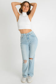 Pantalón de denim, fit recto, cintura alta con pretina, trabillas, bolsillos delanteros y traseros de parche. Cierre frontal con botón y cremallera oculta. Detalle frontal de rotos.