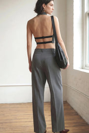 Pantalón de fit wide leg, cintura alta con pretina y trabillas, pinzas frontales con raya frontal, bolsillos delanteros, vivo decorativo posterior, cierre frontal con broche y cremallera ocultos.