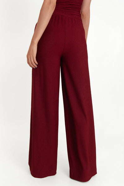 Pantalón de fit wide leg, cintura alta elástica con plisados y detalle de textura en tejido.