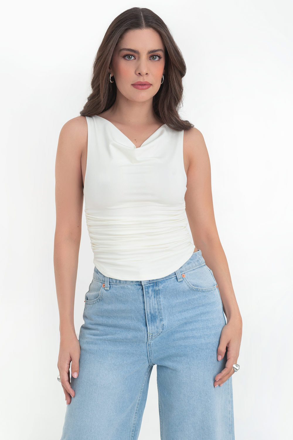 Top corto de fit ajustado, sin mangas, cuello barco con escote fluido, plisados en costados y bajo curveado.