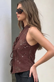 Top halter bordado de cuello mao, fit ajustado, sin mangas, pinzas frontales y cruce frontal con lazos amarrables.