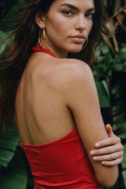 Top corto de cuello halter fluido, sin mangas, fit ajustado y escote en espalda.