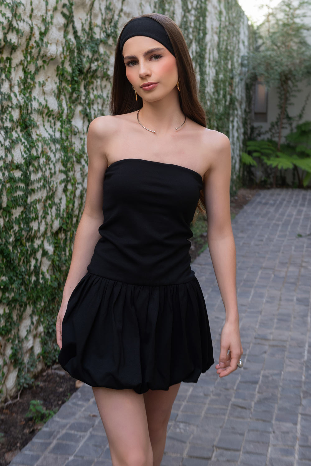 Vestido corto globo, strapless, de fit ajustado, escote recto, bajo con acabado en volumen y plisados en cadera.