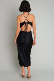 Vestido midi satinado de fit recto, escote fluido con plisados en sisa, tirantes delgados con lazado ajustable posterior, cut out en costados y espalda. Cierre posterior con cremallera oculta.